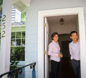 couple in doorway at a house showing